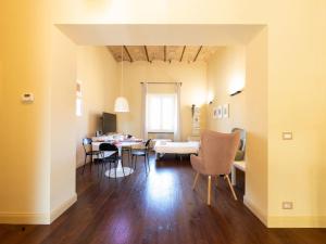 a dining room and living room with a table and chairs at The Best Rent - Elegant two-bedroom apartment close to Saint Peter's Basilica in Rome