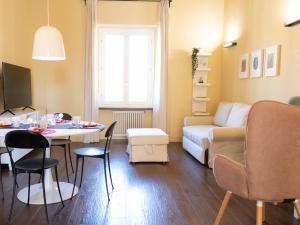 a small living room with a table and a couch at The Best Rent - Elegant two-bedroom apartment close to Saint Peter's Basilica in Rome +15 photos