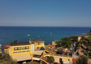 a view of a town with the ocean in the background at Ulivo in Diano Marina