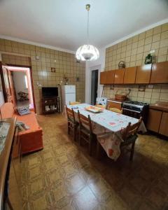 a large kitchen with a table and chairs in a room at Tenuta Aquilae in Castrofilippo