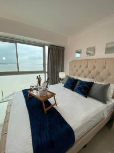 a large bedroom with a large bed with a table at Ecusuites Riverfront One Vista al Río Jacuzzi Hidro in Guayaquil +35 photos