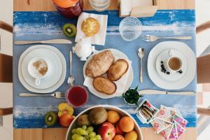 a blue table topped with plates and bowls of food at B&B Castello Otranto in Otranto