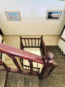 a view from the top of a staircase with a wooden railing at Afrodite Hotel Apartments in Myrina