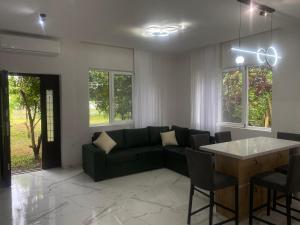 a living room with a couch and a table at OrAnge villa in Gonio