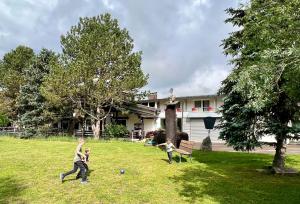 two boys playing with a ball in a yard at Landhotel Tanneneck - ideal für Gruppen, Familien und Hunde in Löffingen