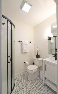 a white bathroom with a toilet and a sink at Red Hill Bed and Breakfast in Lovingston