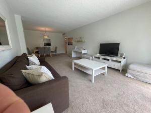 a living room with a couch and a tv at Ocean Reserve 207 - STR 2270 in Miami Beach