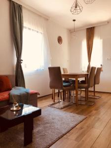 a living room with a table and chairs at Guesthouse D&D in Ličko Petrovo Selo