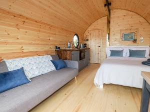 a bedroom with a bed and a couch in a cabin at Stargaze in Truro