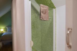 a shower with a towel hanging on a wall at By les Climats - L'Angevin - Gevrey-Chambertin in Gevrey-Chambertin