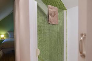 a shower with a towel hanging on a wall at L'Angevin - Gevrey-Chambertin in Gevrey-Chambertin