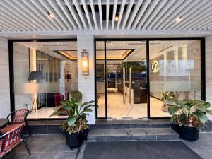 a store front with glass doors and potted plants at Zest Metropole in Colombo