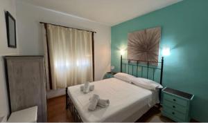 a bedroom with a bed with two towels on it at Casa Lala in Moraira +10 photos