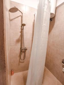 eine Dusche mit Duschvorhang im Bad in der Unterkunft TIP TOP apartment in Chalkida