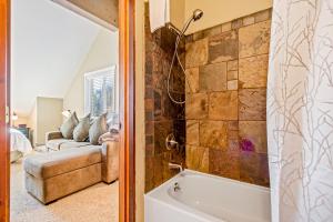 a bathroom with a tub and a couch at Crystal Run in Sandpoint +44 photos