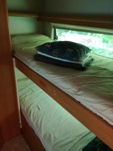 a bunk bed with a pillow on top of it at Zielony Port numer 3 in Władysławowo