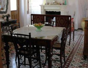 a dining room with a table with a bowl of fruit on it at Villa Ermis in Lákka