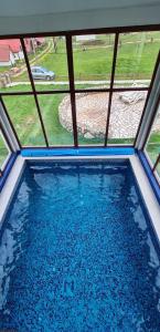 a view of a swimming pool through a window at Eco Village Pavlovic in Žabljak