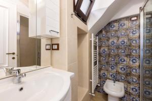 a bathroom with a sink and a toilet at Corte San Vincenzo in Ugento