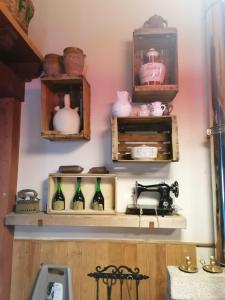 Casa Rural Alto Santiago في Santiago del Collado: مطبخ مع رفوف وزجاجات وموقد
