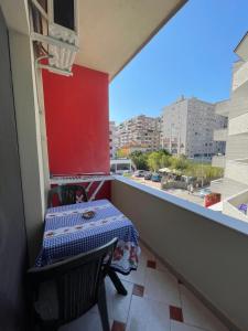 a balcony with a table and a view of a city at Festim hotel in Durrës