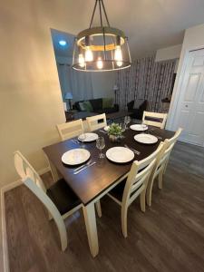 a dining room table with chairs and a dining room at Nakiska, 2 Bed 1 Bath with Mtn Views in Canmore