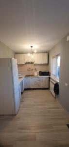 a kitchen with white cabinets and a white refrigerator at Casa Valentin in Corbu +14 photos