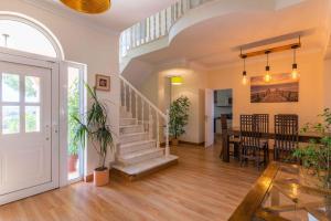 a living room with a staircase and a dining room at Villa Ferragudo, Piscina e Mesa de Bilhar! in Ferragudo