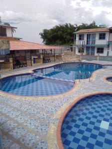 - une grande piscine revêtue de carrelage bleu et blanc dans l'établissement Finca Hotel La Marina, à Quimbaya