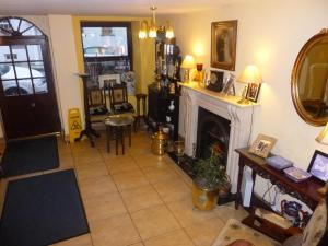 a living room with a fireplace and a mirror at Ben View Guesthouse in Clifden