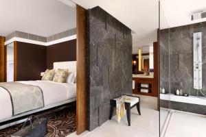 a bedroom with a bed and a glass wall at The Langham, Shanghai, Xintiandi in Shanghai