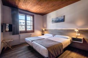Cama o camas de una habitación en Hotel SNÖ Mont Romies