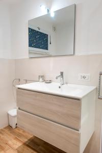 a bathroom with a sink and a mirror at N255 - Numana, trilocale con aria condizionata in Marcelli +14 photos