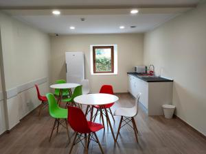 a room with tables and chairs and a kitchen at El Pino in Penagos +29 photos