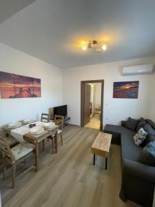 a living room with a couch and a table at Elena villa-apartments in Asklipiḯon