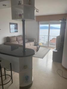 a living room with a couch and a table at precioso apartamento con vistas al mar in Sanxenxo