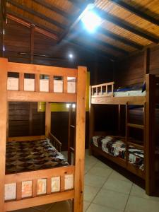 2 łóżka piętrowe w pokoju z sufitem w obiekcie Estância Agnus Dei w mieście Pirenópolis