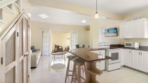a kitchen with white cabinets and a counter top at Palm View 4 in Watts Village