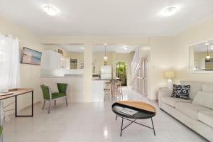 a living room with a couch and a table at Palm View 4 in Watts Village +7 photos