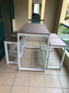 a picnic table and bench sitting on a porch at AQUATIKA BEACH APT 1ST FL in Loiza