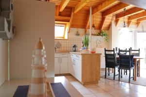 a kitchen and dining room with a table and chairs at Ferienhaus Poseidon in Dorum-Neufeld