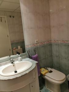 a bathroom with a sink and a toilet at Apartamento primera linea junto al puerto in Denia
