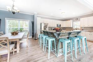 a kitchen with a table and chairs and a counter top at Absolute Beach in Destin