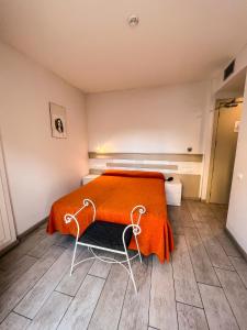 a bedroom with a bed with an orange blanket at Apartamentos Comfort Calella in Calella