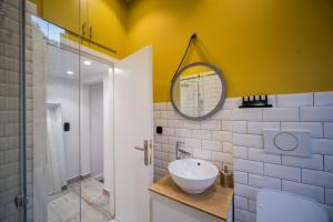 a bathroom with a sink and a mirror at Studio Reale Corfu in Corfu