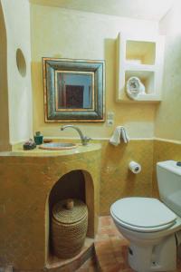 a bathroom with a toilet and a fireplace at Noqta Space in Essaouira