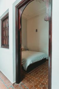 a large mirror in a room with a bed at Noqta Space Coworking Coliving Space in Essaouira
