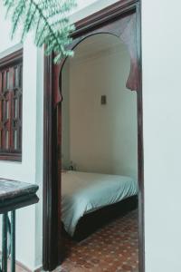 a mirror in a bedroom with a bed in it at Noqta Space Coworking Coliving Space in Essaouira