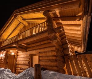 a log cabin with a staircase in the snow at Chalet Resort Sölden in Sölden