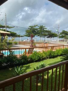 a view of a fence and a swimming pool at Flat Beira Mar Porto Segur in Porto Seguro